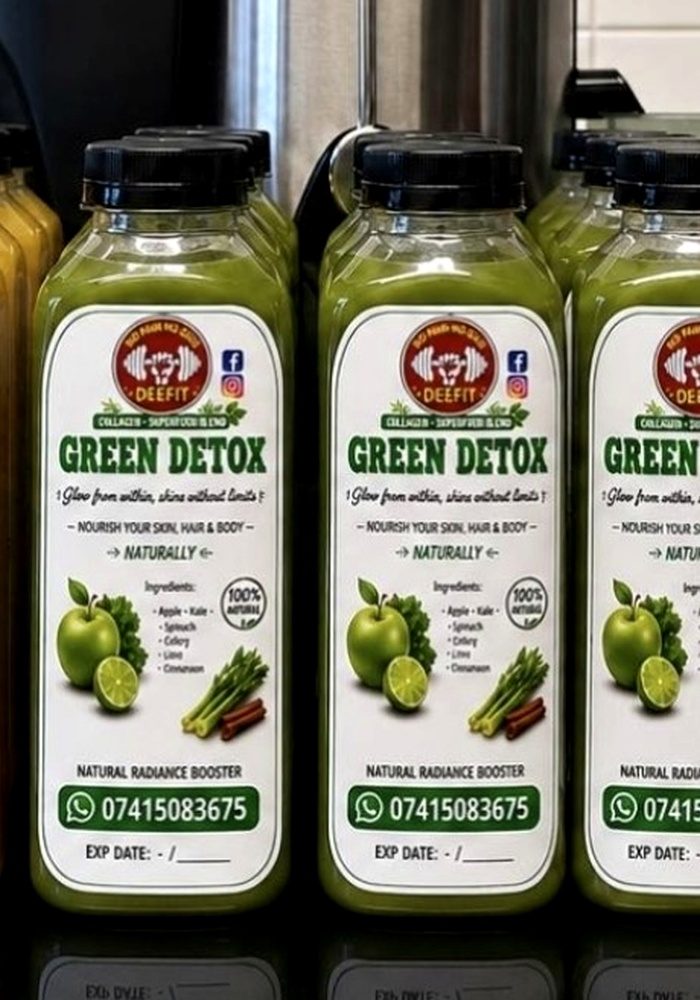 Bottles of DEEFIT Green Detox, a green apple, kale, spinach and celery juice