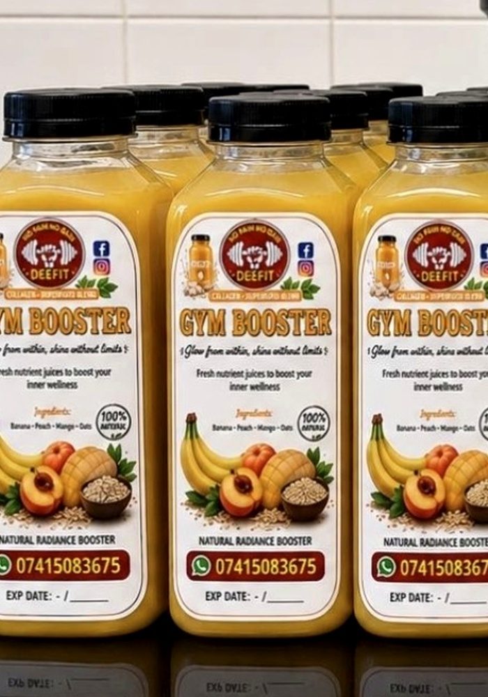 Bottles of DEEFIT Gym Booster, a golden banana, peach, mango and oat juice